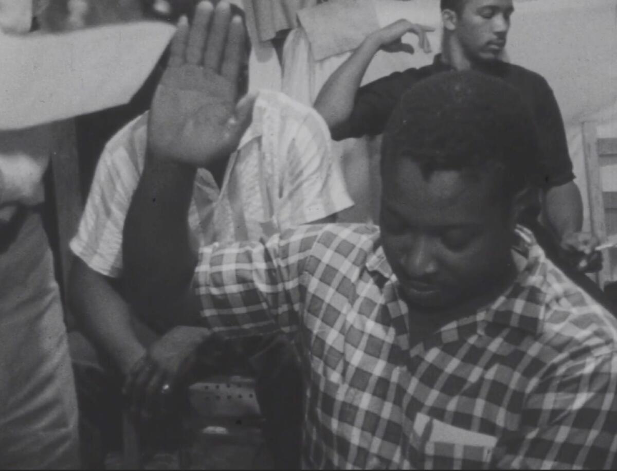 Wharlest Jackson Sr. raises his right hand to take an oath.