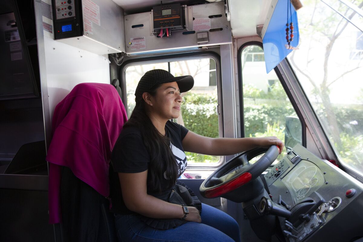 Jennifer Ramirez drives her food truck on the narrow roads of Bel-Air. She feeds the construction workers who otherwise have no access to restaurants.