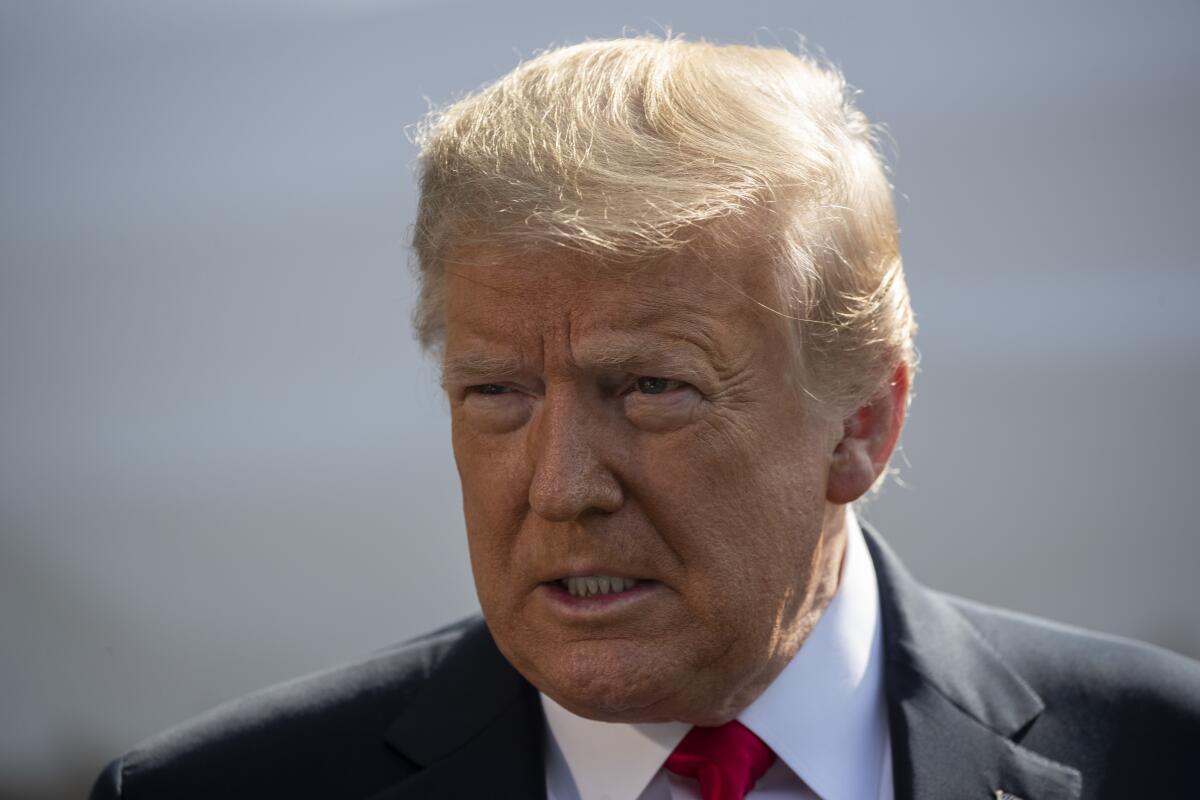 President Donald Trump speaks with reporters before departing on Marine One last month. 