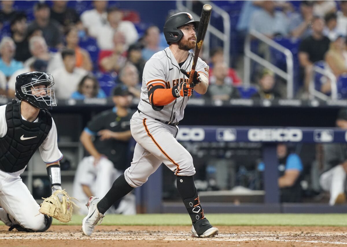 San Francisco Giants Donovan Walton hits a grand slam during the fourth inning of a baseball game against the Miami Marlins, Sunday, June 5, 2022, in Miami. (AP Photo/Marta Lavandier)