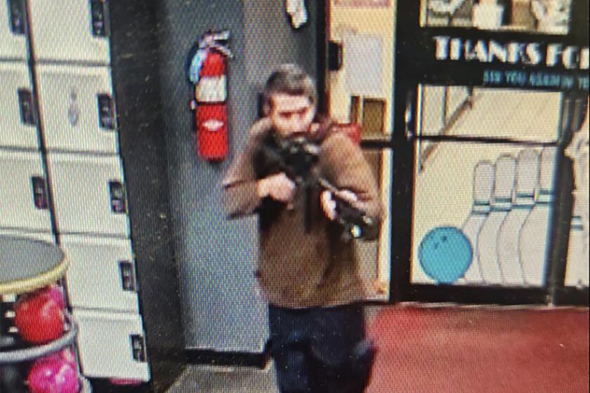 En esta imagen difundida por el Departamento de Policía del condado Androscoggin se ve a un hombre armado no identificado que apunta su fusil mientras ingresa al local Sparetime Recreation, el miércoles 25 de octubre de 2023, en Lewiston, Maine. (Departamento de Policía del condado Androscoggin via AP)