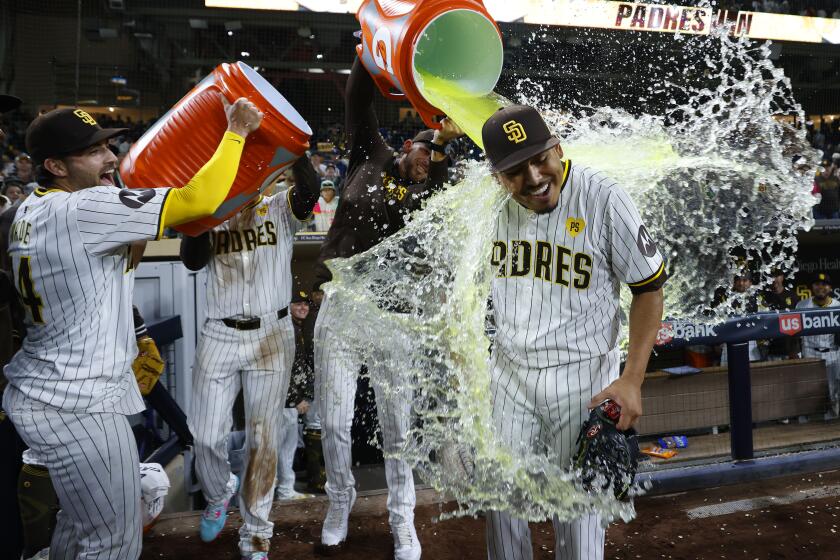 San Diego, CA - May 28: San Diego Padres players douse pitcher Jeremiah Estrada after a 4-0 win against the Miami Marlins at Petco Park on Monday, May 28, 2024 in San Diego, CA. Estrada struck out 13 batters in a row. (K.C. Alfred / The San Diego Union-Tribune)