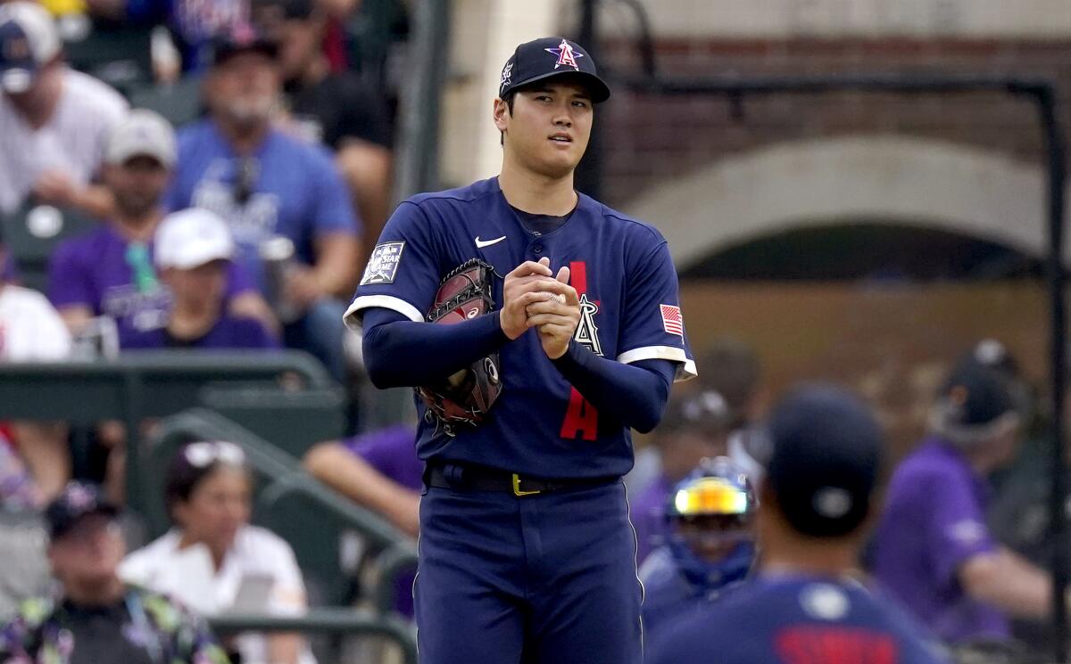 American League’s Shohei Ohtani looks to his fielders before throwing his first pitch during the MLB All-Star game.