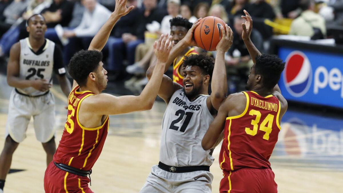 Colorado forward Evan Battey, center, is trapped with the ball by USC forwards Bennie Boatwright, left, and Victor Uyaelunmo in the second half.