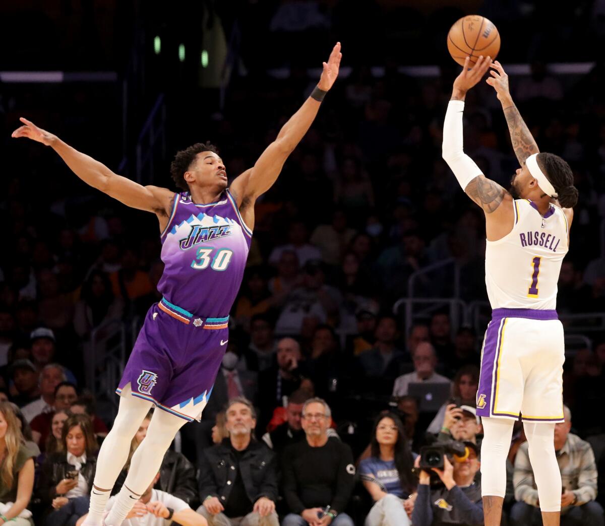 Lakers guard D'Angelo Russell shoots a three-pointer over Jazz guard Ochai Agbaji.