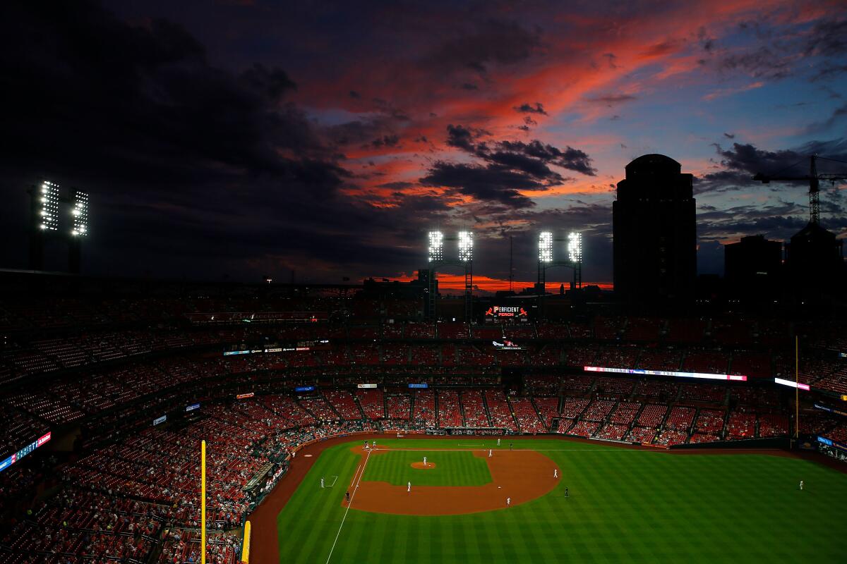 The sun sets over Busch Stadium during a game between the St. Louis Cardinals and the Cincinnati Reds on June 4, 2019.