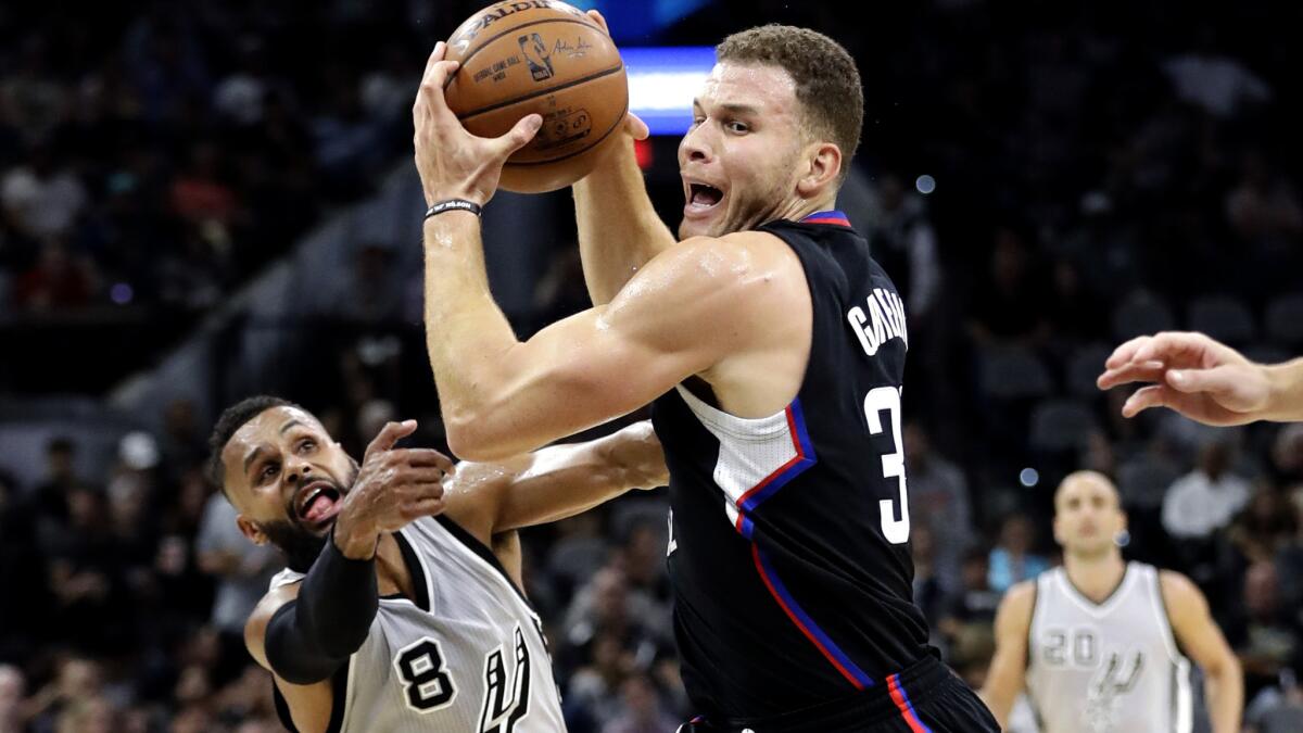 Clippers forward Blake Griffin drives to the basket past San Antonio Spurs guard Patty Mills during the first half.