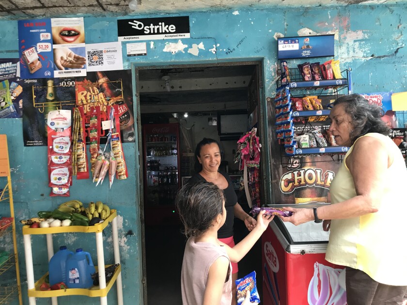 Women and a child at a shop counter 