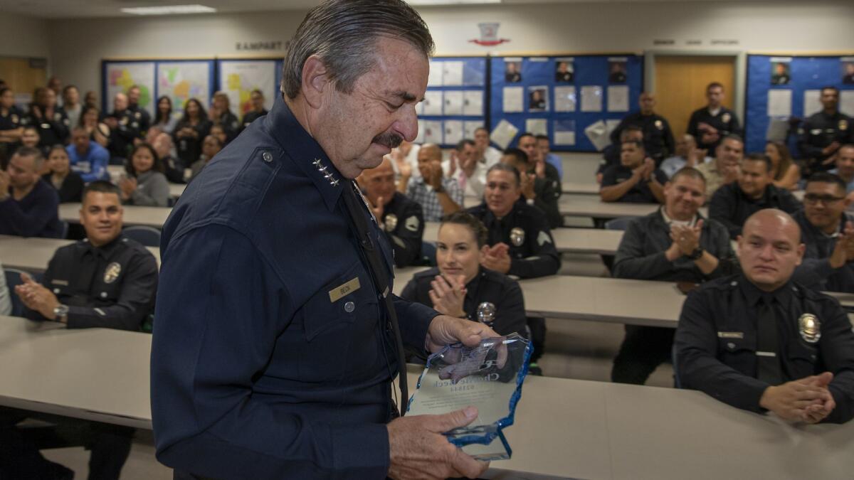 Beck clutches an award he was given during a May 24 farewell visit to Rampart station, where he started his career in 1977.