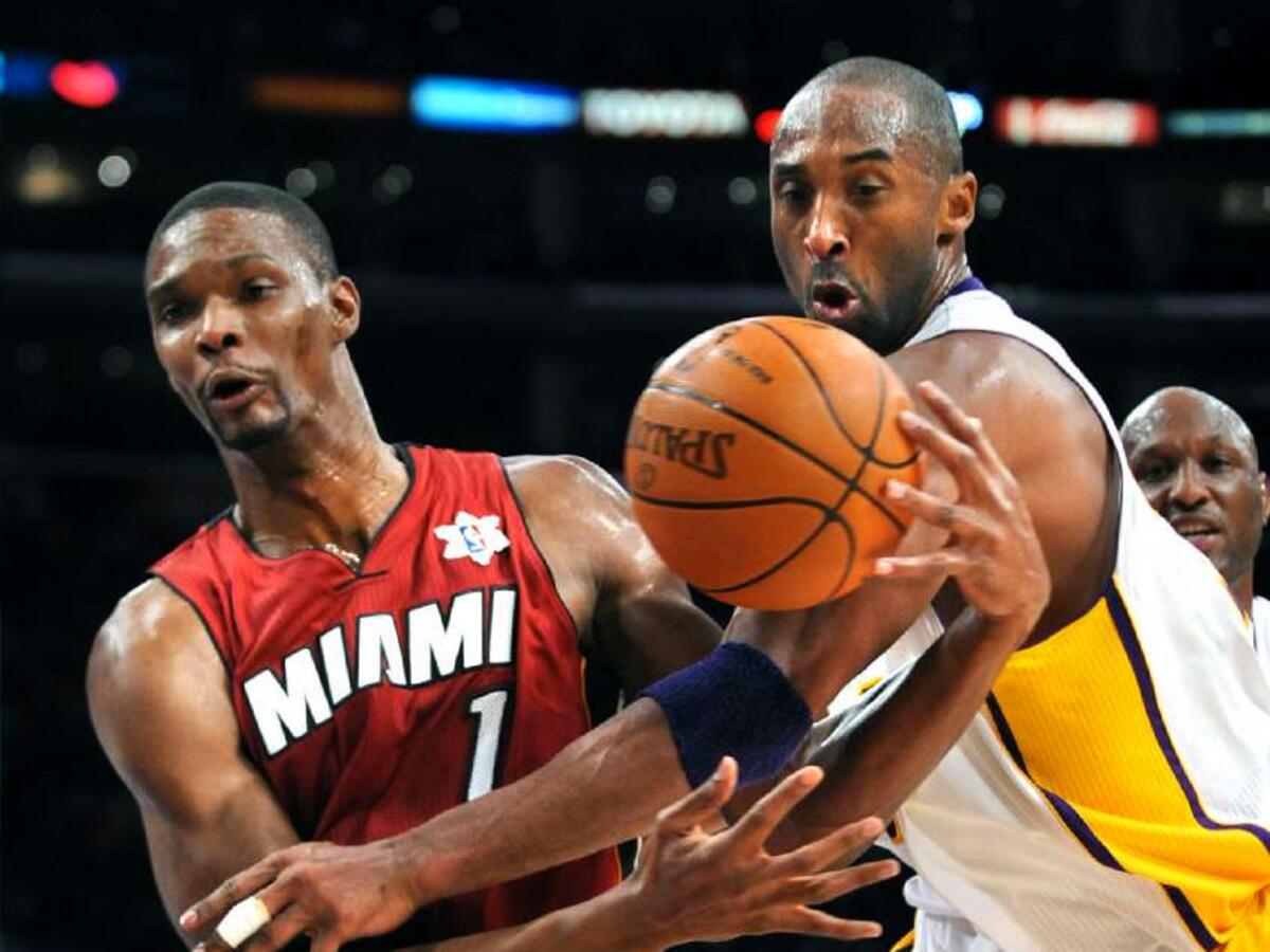 Heat forward Chris Bosh is fouled by Lakers guard Kobe Bryant on Christmas Day in 2010.