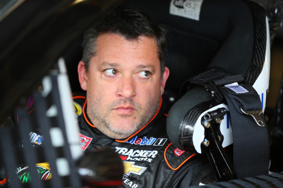Tony Stewart sits in his car in the garage area during practice for the NASCAR Sprint Cup Series Cheez-It 355 at New York's Watkins Glen International on Aug 7.