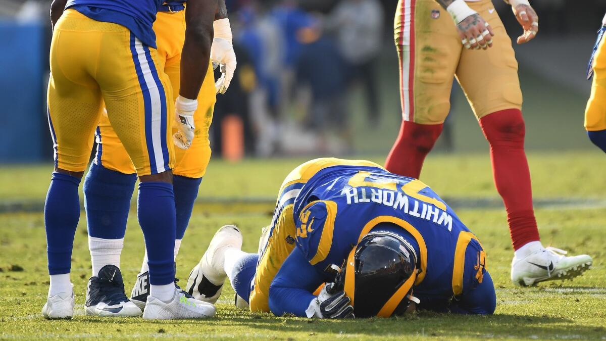 Rams tackle Andrew Whitworth is injured against the 49ers at the Coliseum.