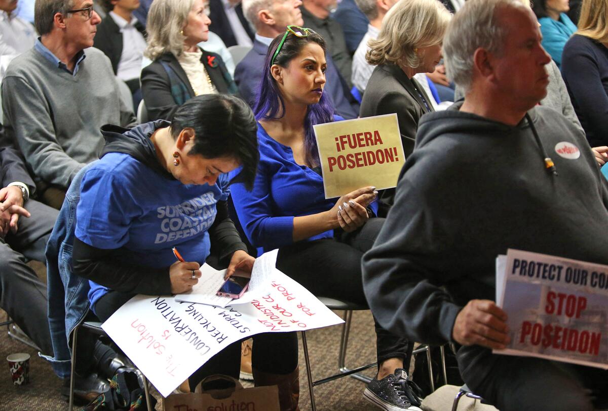 Demonstrators against Poseidon's planned ocean desalination plant in Huntington Beach listen during a Santa Ana Regional Water Quality Control Board hearing Friday.