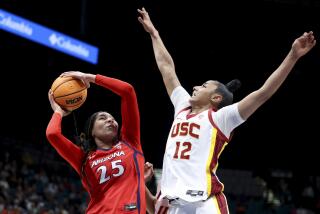 Arizona forward Breya Cunningham (25) shoots over Southern California guard JuJu Watkins.