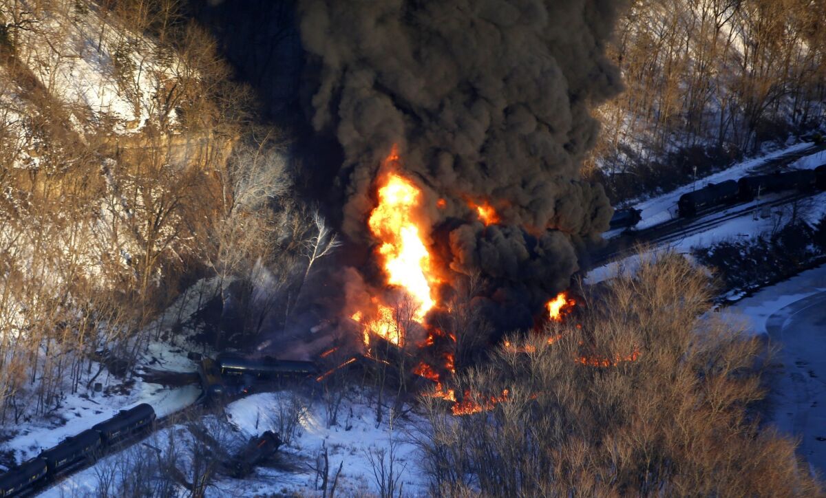 Smoke and flames erupt from the scene of a train derailment March 5, 2015, near Galena, Ill. A BNSF Railway freight train loaded with crude oil derailed in a rural area where the Galena River meets the Mississippi.