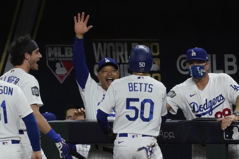 Los Angeles Dodgers' Mookie Betts celebrates after scoring against the Tampa Bay during the sixth inning in Game 6 of the baseball World Series Tuesday, Oct. 27, 2020, in Arlington, Texas. (AP Photo/Tony Gutierrez)