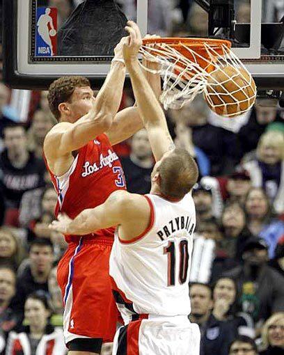 Clippers forward Blake Griffin dunks over Trail Blazers center Joel Przybilla during the first half. Griffin's numbers Minutes: 44 Points: 20 Rebounds: 18
