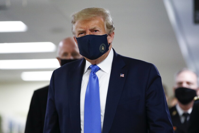 President Trump wears a protective mask Saturday as he visits Walter Reed National Military Medical Center in Bethesda, Md.