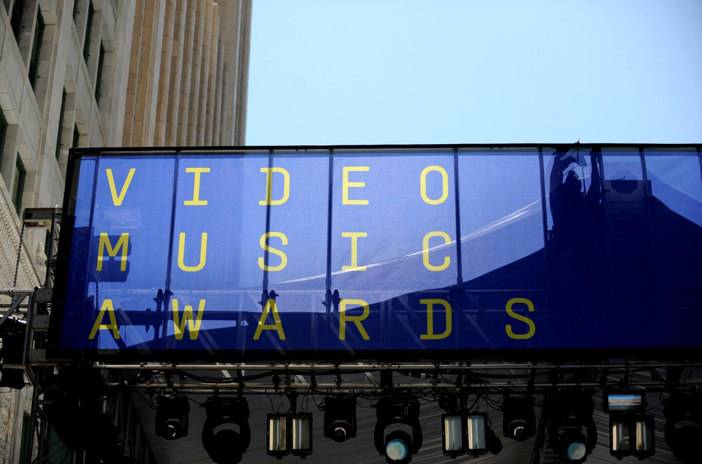 A crew member secures a sign for MTV's VMA show on Broadway in downtown Los Angeles.