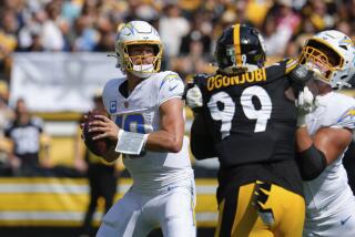 Los Angeles Chargers quarterback Justin Herbert, left, looks for an open receiver.