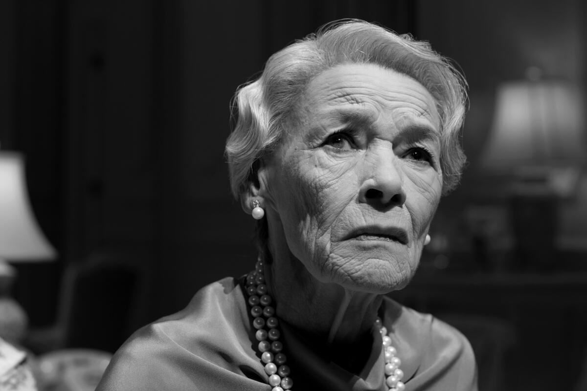 Glenda Jackson, in a black and white close-up, wears a blouse, pearls and a 1920s hairdo.