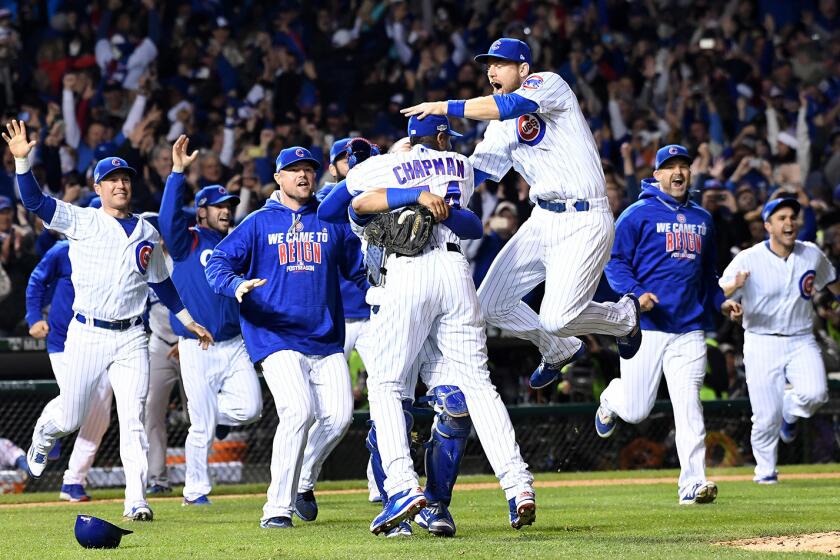 Cubs players celebrate after defeating the Dodgers in Game 6 of the NLCS at Wrigley Field in Chicago.