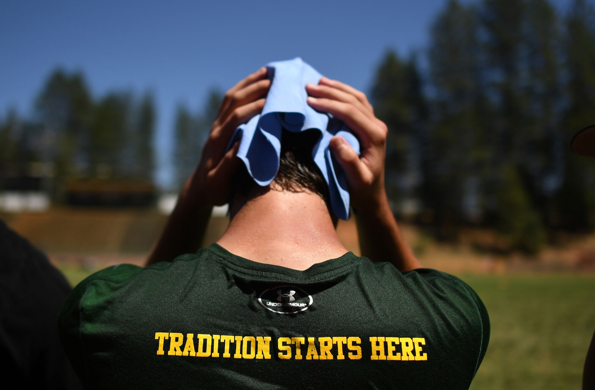 A Paradise football player cools down during a training camp practice session.