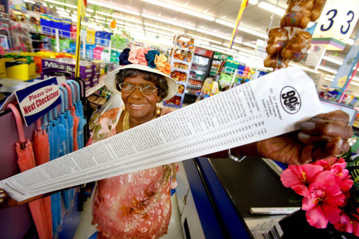 Emelia De-Four, 99, holds the receipt from her free shopping spree at the 99 Cents Only Store. She picked out 135 items valued at $143.88, including tax.