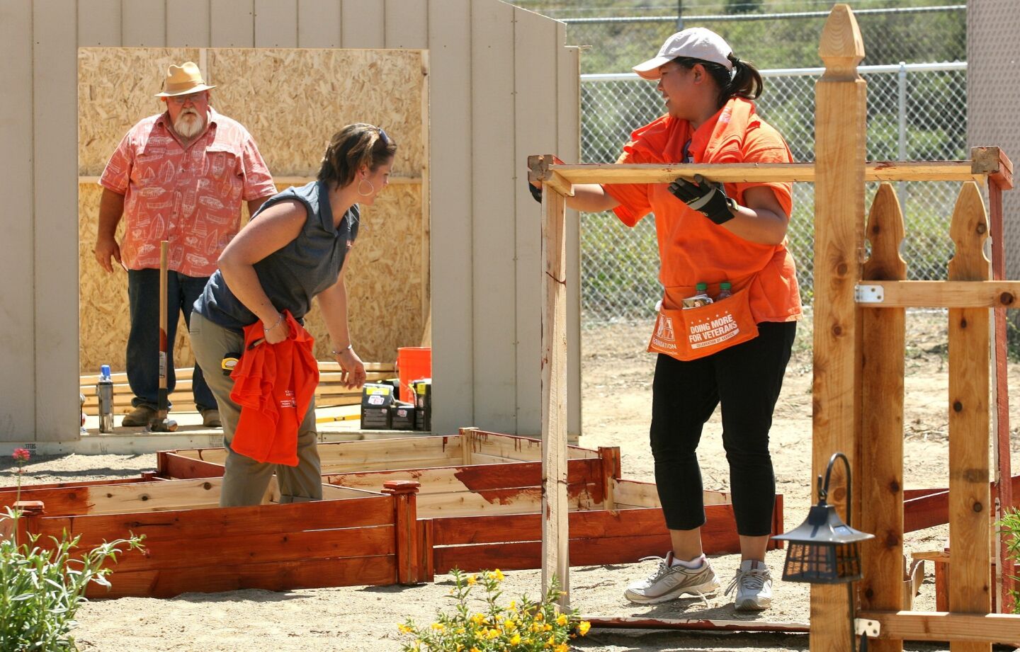 Home Depot volunteers Gary Crew, Emily Simpson and Christine Vincent help build the garden on an old U.S. Navy housing village in San Pedro that will become the nation's first permanent housing complex exclusively for female veterans.