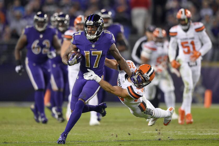 Ravens wide receiver Mike Wallace (17) tries to break free from Cleveland Browns defensive back Ed Reynolds II after a second half catch on Nov. 10.