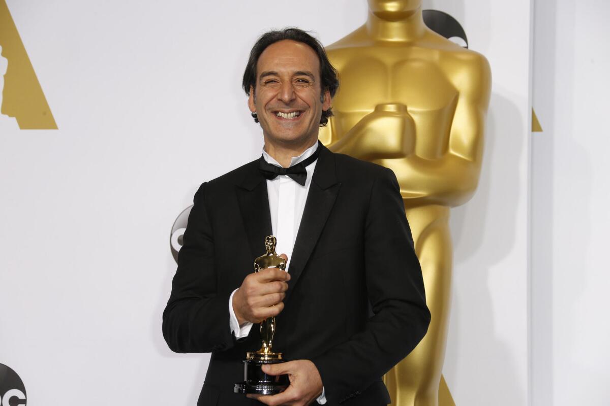 Film composer Alexandre Desplat with his Oscar for composing "The Grand Budapest Hotel" at the 87th Academy Awards in 2015.