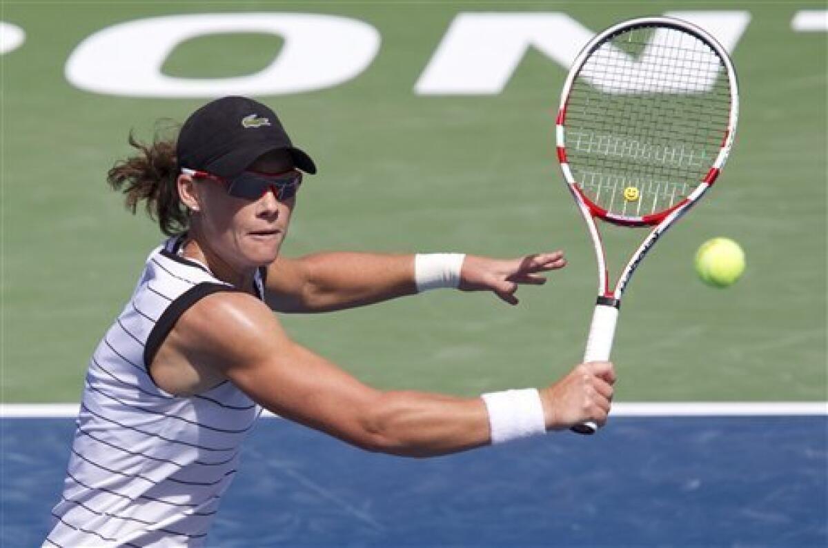 Samantha Stosur, of Australia, makes a return against Li Na, of China, at the Rogers Cup women's tennis tournament in Toronto Thursday, Aug. 11, 2011. (AP Photo/The Canadian Press, Darren Calabrese)