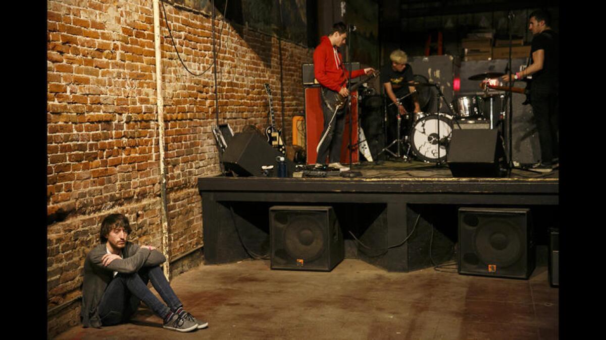 A fan waits for the next band to set up at the Smell.