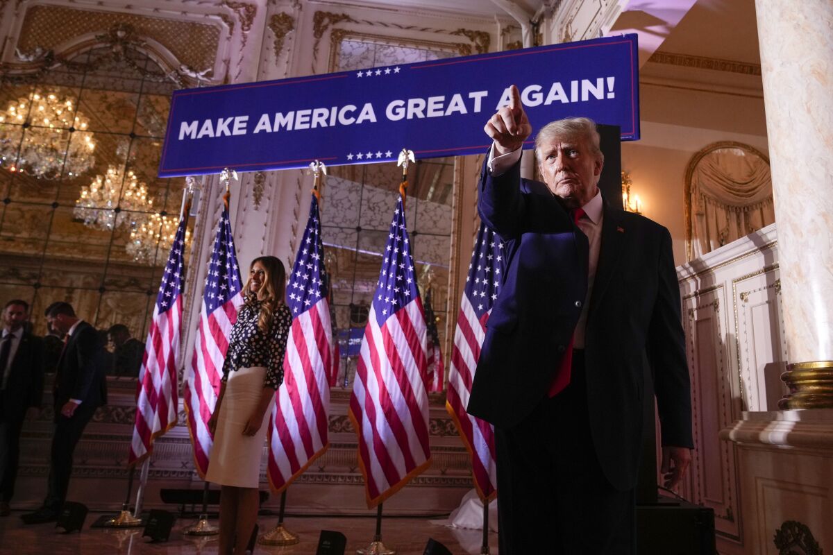 Former President Trump stands near a row of U.S. flags