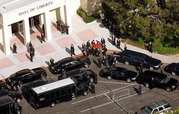The casket containing the body of Michael Jackson is carried to the hearse at Forest Lawn cemetery.