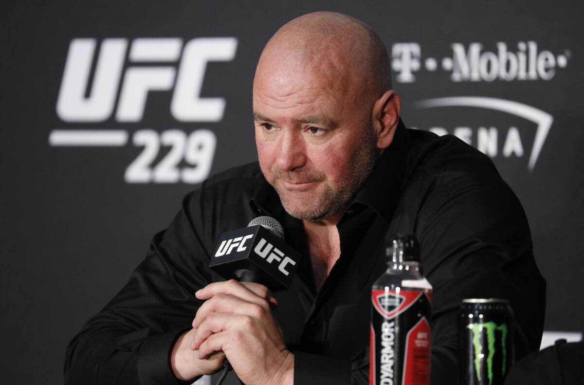 UFC president Dana White sits in front of a microphone and speaks at a news conference Las Vegas.