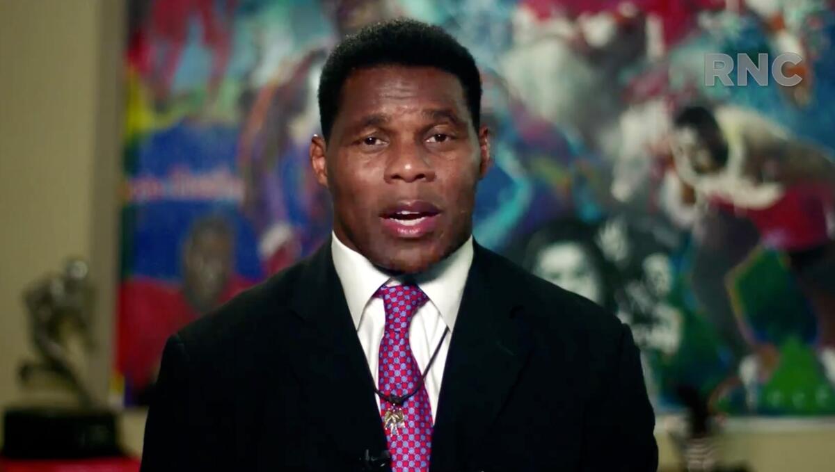 Herschel Walker speaking into a camera