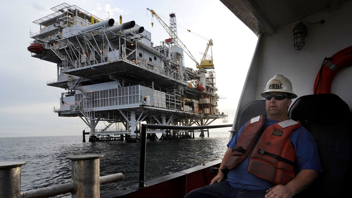 A crew member arrives by boat at an oil platform near Santa Barbara. The state is preparing to fight any efforts by President Trump to expand drilling along the coast.