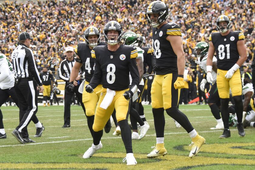 Pittsburgh Steelers quarterback Kenny Pickett (8) celebrates beside teammates after scoring a touchdown against the New York Jets during the second half of an NFL football game, Sunday, Oct. 2, 2022, in Pittsburgh. (AP Photo/Don Wright)