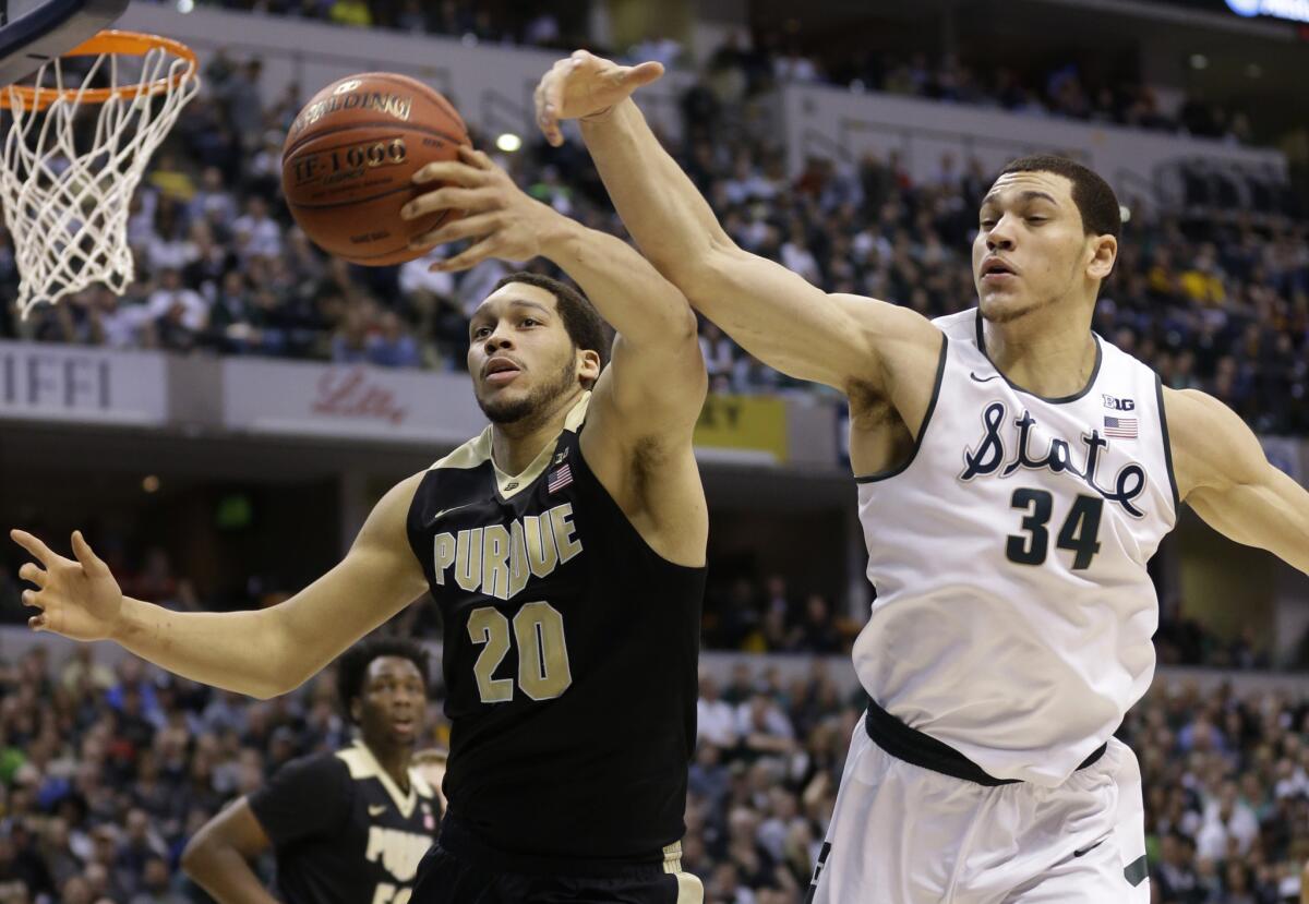 Purdue forward A.J. Hammons and Michigan State forward Gavin Schilling battle for a rebound during the first half of the Big Ten Conference championship game on March 13.