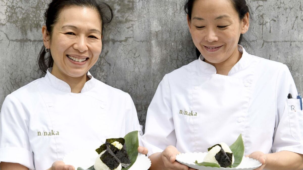 Niki Nakayama, left, and Carole Iida-Nakayama prepare onigiri at their Michelin-starred restaurant n/naka.