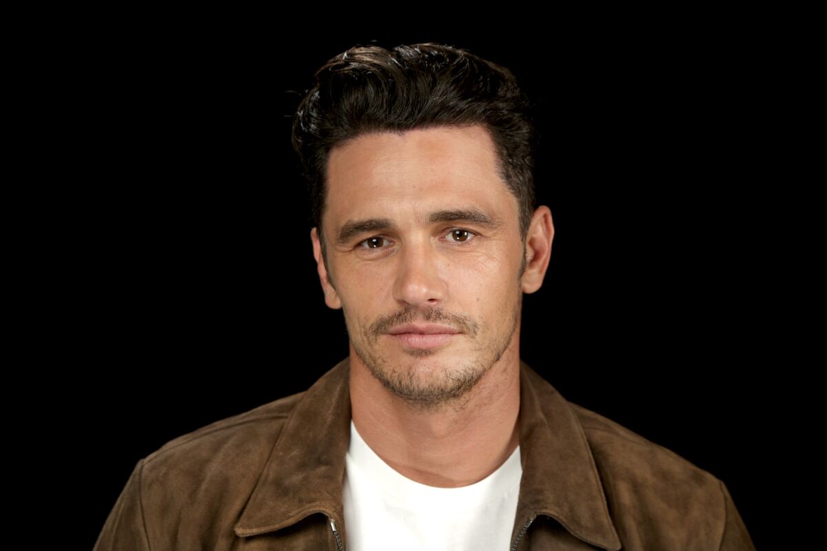 A portrait of James Franco in a brown suede jacket and white shirt