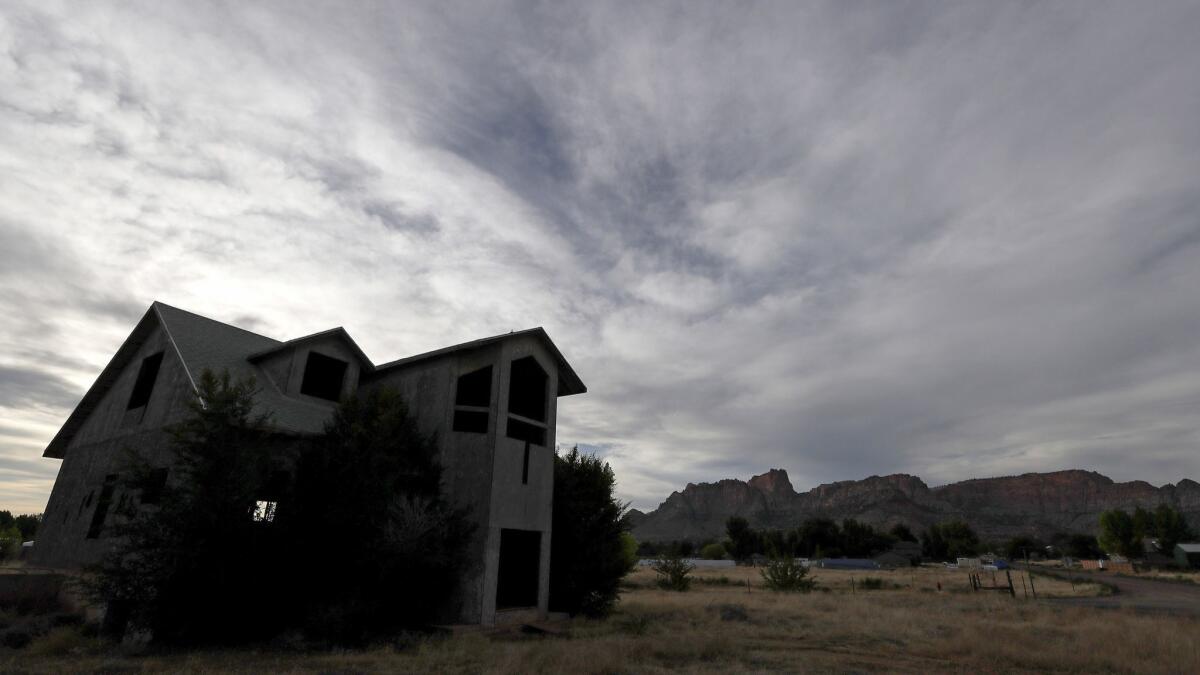 Homes constructed for members of the Fundamentalist Church of Jesus Christ of Latter-day Saints that are half-built or abandoned dot the landscape of Colorado City, Ariz.