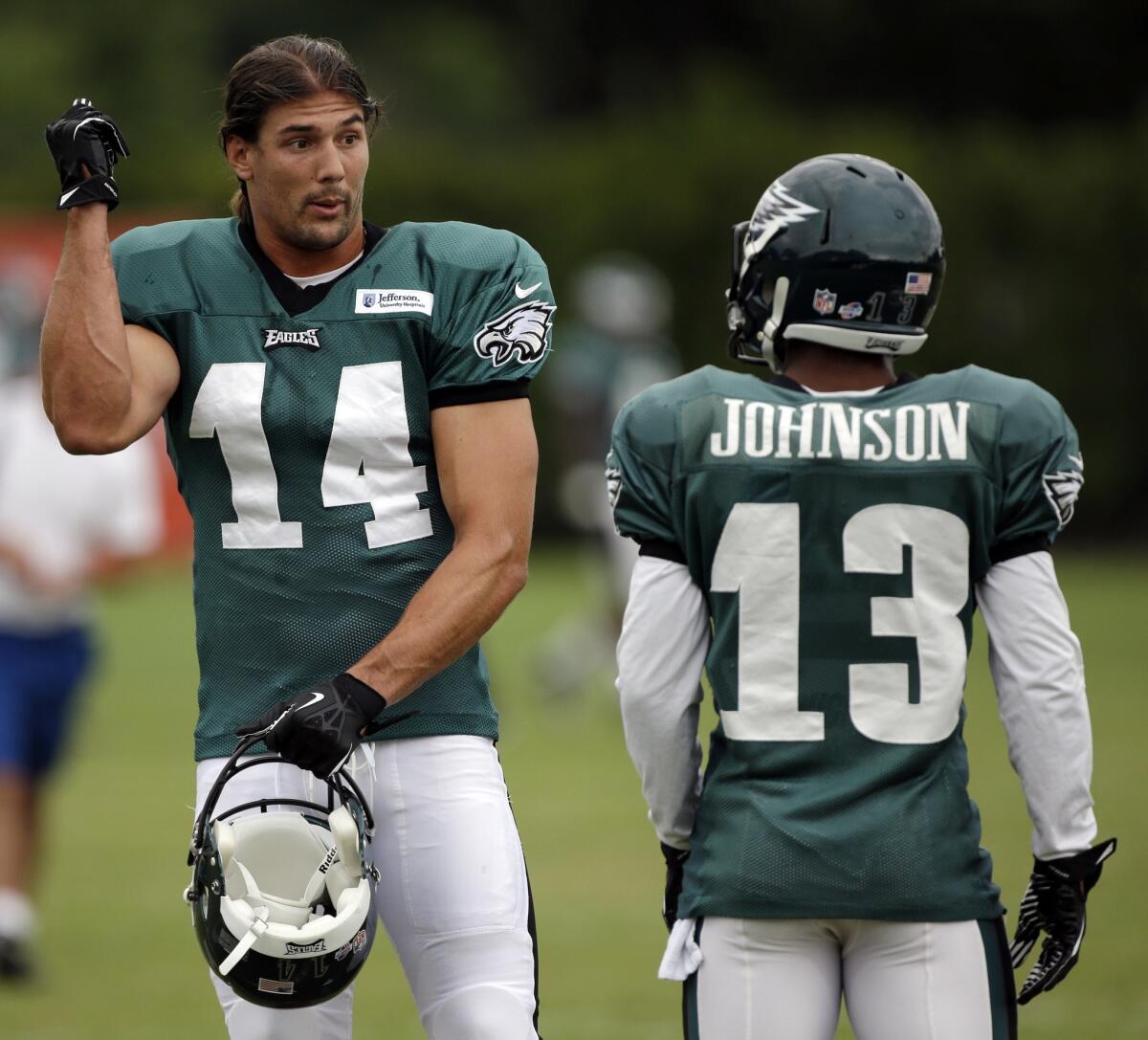 Philadelphia Eagles wide receivers Riley Cooper, left, and Damaris Johnson talk during a training camp session Tuesday.