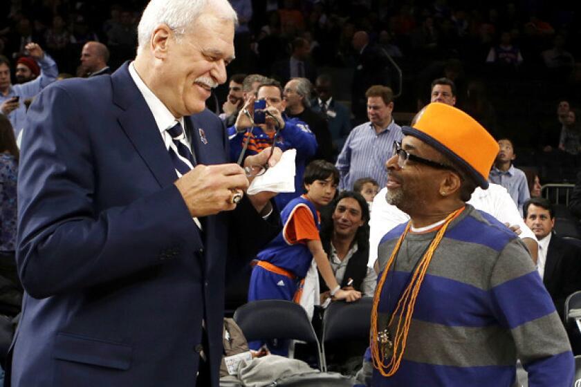 Former Lakers coach Phil Jackson and director Spike Lee talk before a ceremony to honor the 1972-73 New York Knicks championship team during the first half of an NBA game this month.