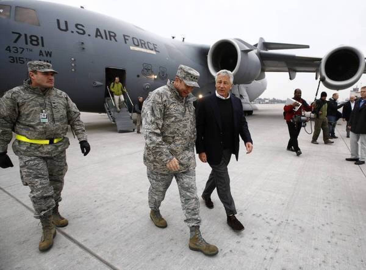 Defense Secretary Chuck Hagel, right, arrives in Germany on Monday.