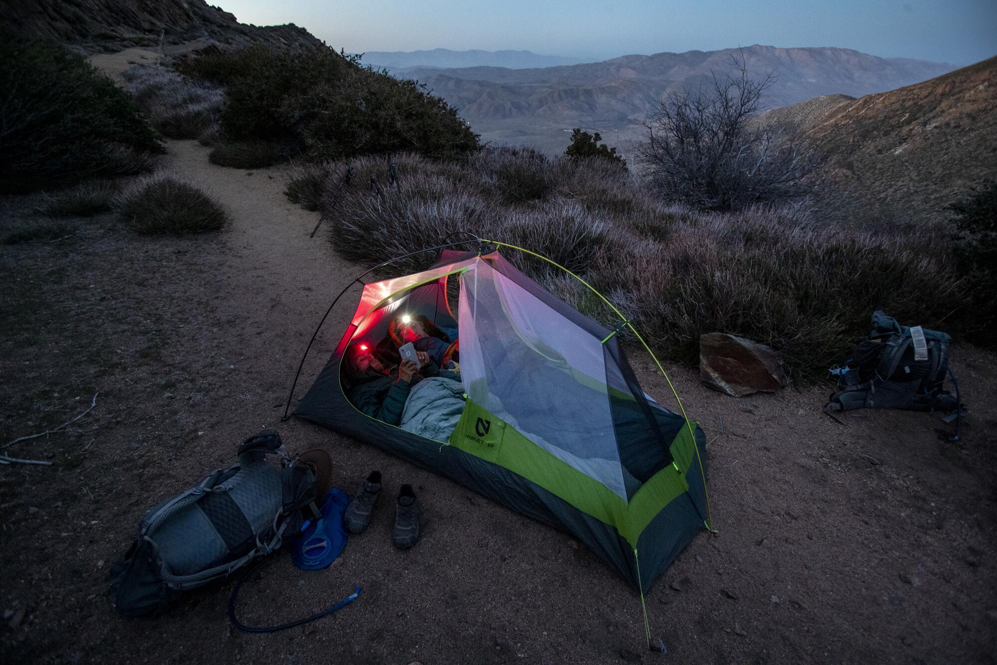 The pair settle in for the night in a tent 