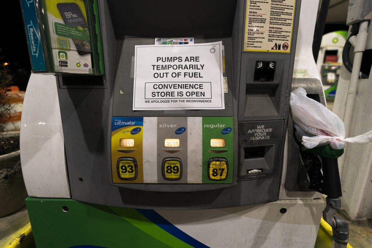 A gas pump at a gas station in Silver Spring, Md., is out of service, notifying customers they are out of fuel, late Thursday, May 13, 2021. Motorists found gas pumps shrouded in plastic bags at tapped-out service stations across more than a dozen U.S. states Thursday while the operator of the nation's largest gasoline pipeline reported making "substantial progress" in resolving the computer hack-induced shutdown responsible for the empty tanks. (AP Photo/Manuel Balce Ceneta)