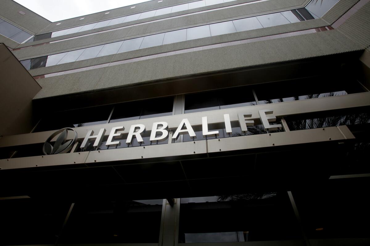 The company sign hangs over the entrance at Herbalife in Torrance.