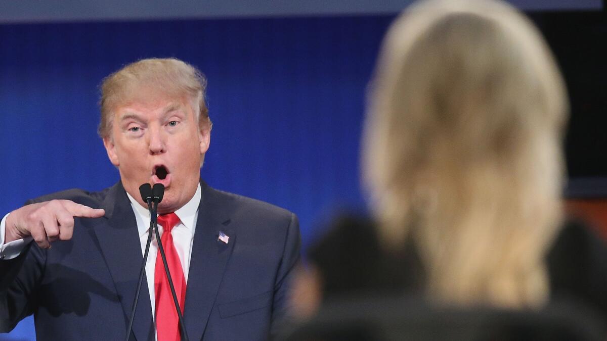 Republican presidential candidate Donald Trump fields a question during the debate held Thursday in Cleveland. His comments about moderator Megyn Kelly, right, have caused controversy.